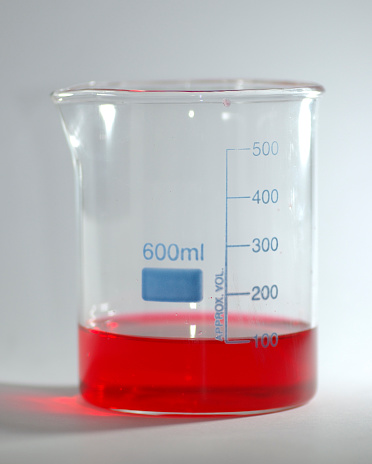 A measuring beaker contiaining some red liquid