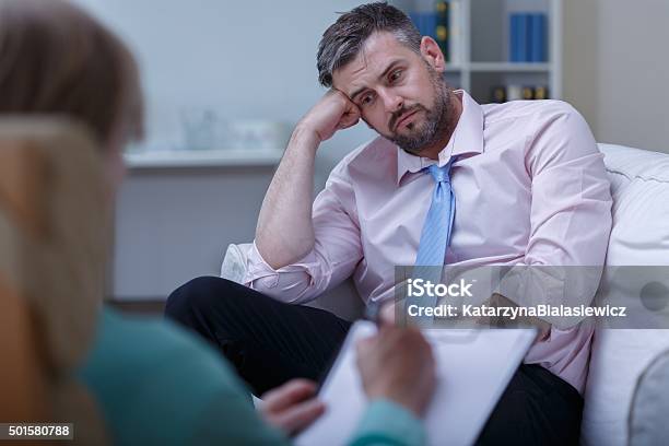 Despair Businessman During Psychotherapy Stock Photo - Download Image Now - 2015, Adult, Advice