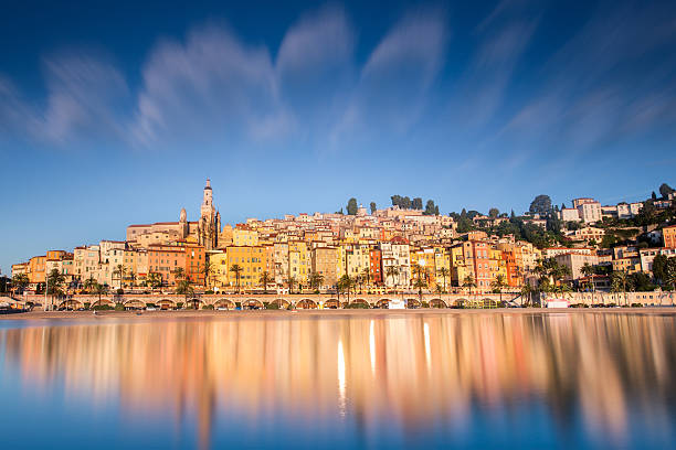 Menton south of France, near Monaco Monte Carlo Scenic view from the sea of Menton city with reflection in the water. Famous place of the french riviera. Beautiful colorful typical architecture. City of lemon and orange fruits. french currency stock pictures, royalty-free photos & images