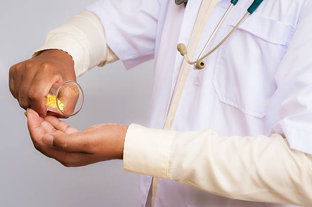 istock Doctor pouring pills on his palm 501592668
