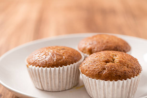 istock Banana cup cake in plate on wood table 501594704