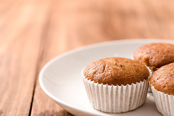 istock Banana cup cake in plate on wood table 501594788