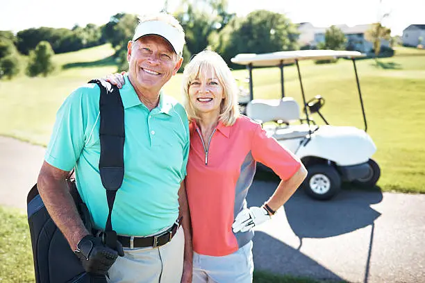 Portrait of mature man and woman out on a golf course