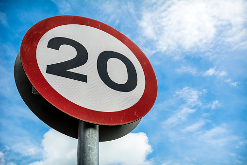 Road sign against sky showing a low speed limit, becoming more common on UK roads