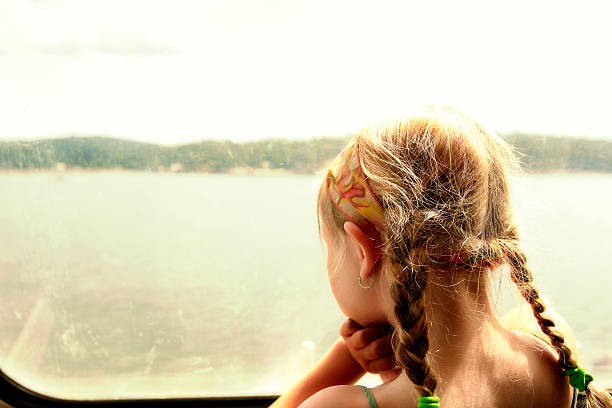 istock Young girl looking through a boat window. 501599230