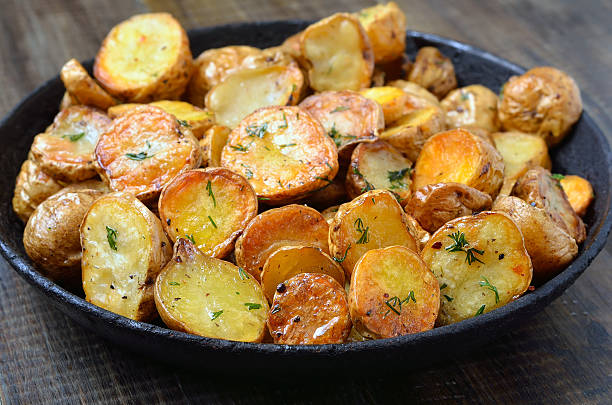 istock Fried potato in pan on wooden table 501599578