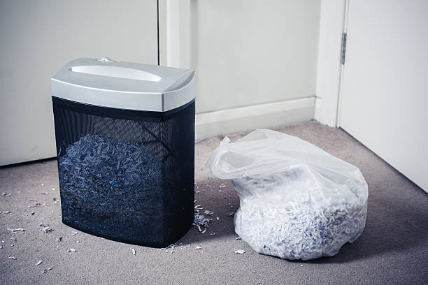 istock Paper shredder and bag of shredded documents 501599733