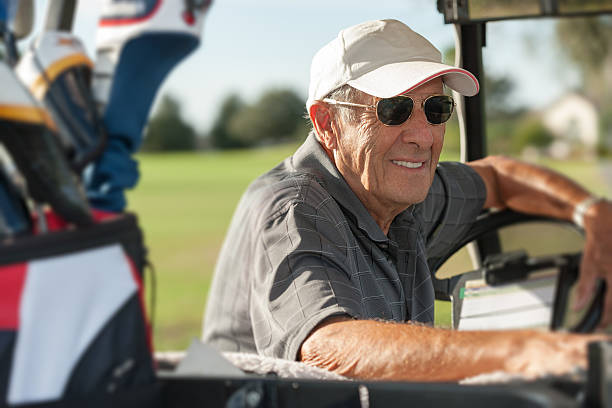 istock Senior golfer sitting in golf cart 501600526