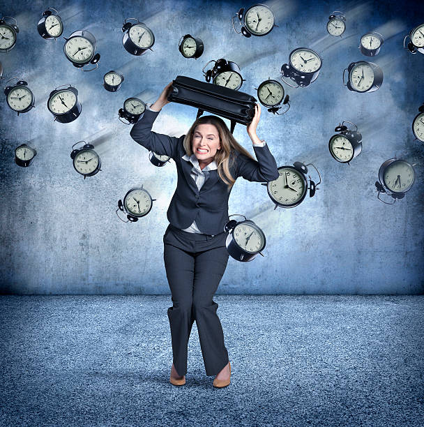 istock Businesswoman Using Briefcase To Protect Himaself From Flying Clocks 501600942