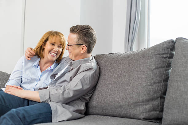 istock Happy loving couple sitting on sofa at home 501601183