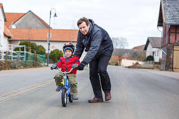 istock Young father teaching  little son to ride a bike 501601785