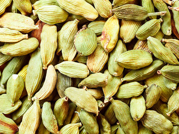 istock Green cardamom pods background 501604712