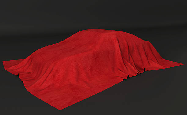 istock Presentation of the car. Autoshow. Car under the tissue. Black backgound 501605324