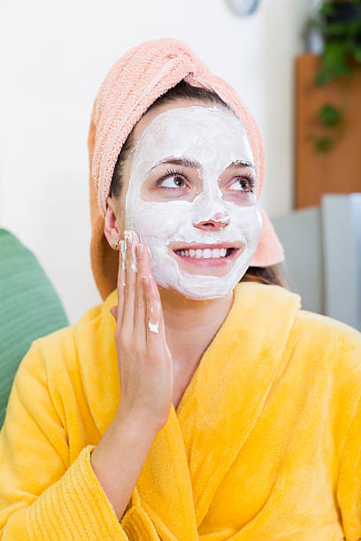 istock Girl applying cream on skin 501606584