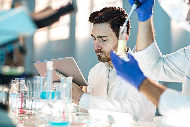 two scientist using digital tablet in laboratory stock photo