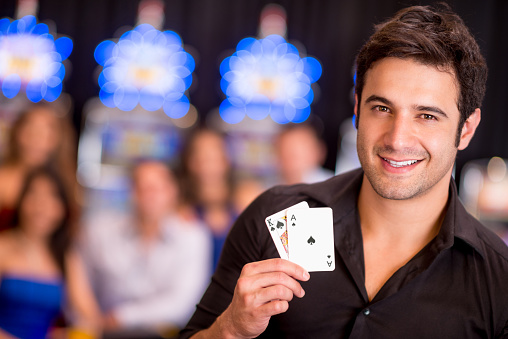 Four aces in the hand. Playing cards on the background of a golden table.
