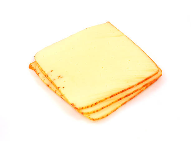 Small stack muenster cheese A small pile of several slices of muenster cheese. munster stock pictures, royalty-free photos & images