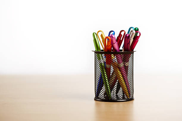 istock Ballpoint pen in metal cup on wooden table 501615419