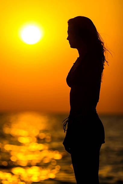 istock Young woman silhouette at sunset 501615811
