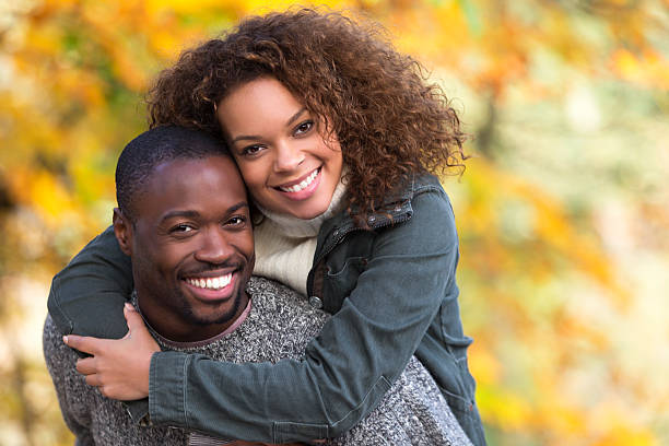 istock Mixed Race Couple Giving Each Other Piggy Backs 501616091