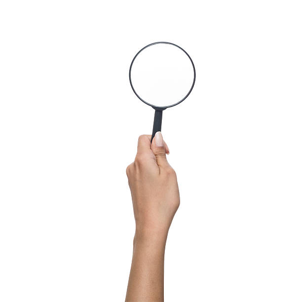 istock Magnifying glass in human hand, isolated  with clipping path 501616127