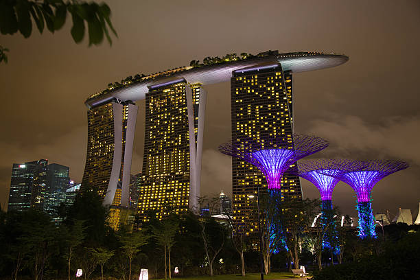 Singapore City, Singapore - May 19, 2014: Marina Bay Sands Hotel seen from the walkway in the Gardens by the Bay in Singapore at night . Marina Bay Sands is an integrated resort fronting Marina Bay in Singapore. Developed by Las Vegas Sands, it is billed as the worlds most expensive standalone casino property at S$8 billion, including cost of the prime land.