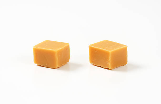 istock Caramel toffee candies on white background 501617560