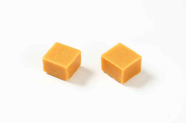 istock Caramel toffee candies on white background 501617584