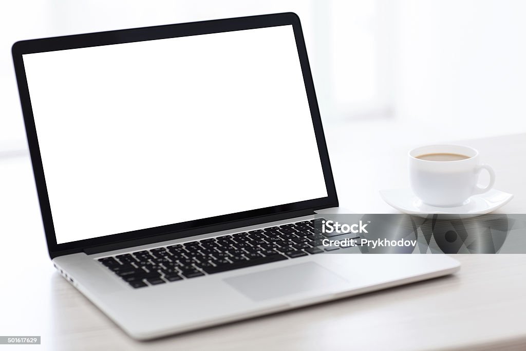 laptop computer with isolated screen on the table laptop computer with isolated screen is on the table with a cup of coffee in a white room Coffee - Drink Stock Photo