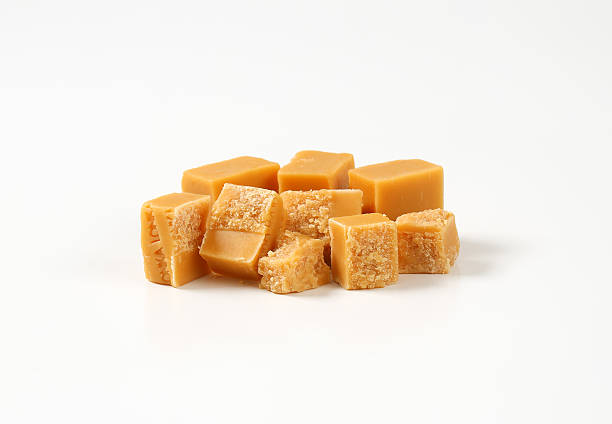istock Caramel toffee candies on white background 501617704