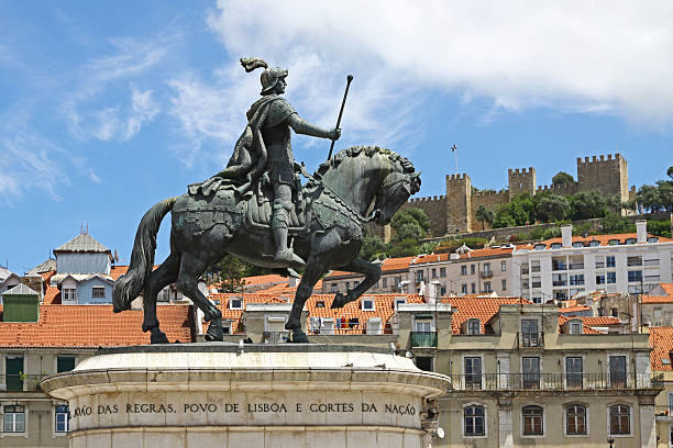 King Jose I Statue Silhouetted Sunburst - Dramatic low-angle silhouette of the bronze equestrian statue of King Jose I in Lisbon's Praça do Comércio, featuring a striking sunburst against a bright blue sky.