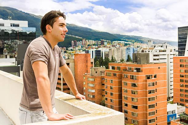 istock young man looking at Quito city view from balcony 501618067