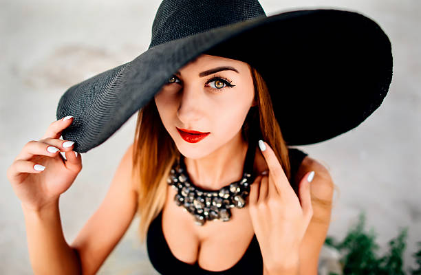 istock Young pretty women on the beach in black hat 501618086