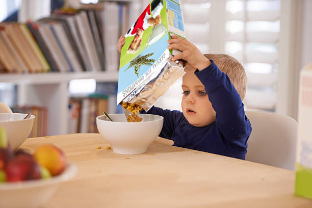 He's making his own breakfast Cropped shot of a young boy pouring his breakfast into a bowl at homehttp://195.154.178.81/DATA/i_collage/pi/shoots/783569.jpg breakfast room photos stock pictures, royalty-free photos & images