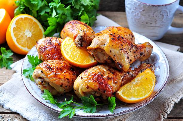 Baked chicken drumstick with orange, smoked paprika, Provencal herbs stock photo