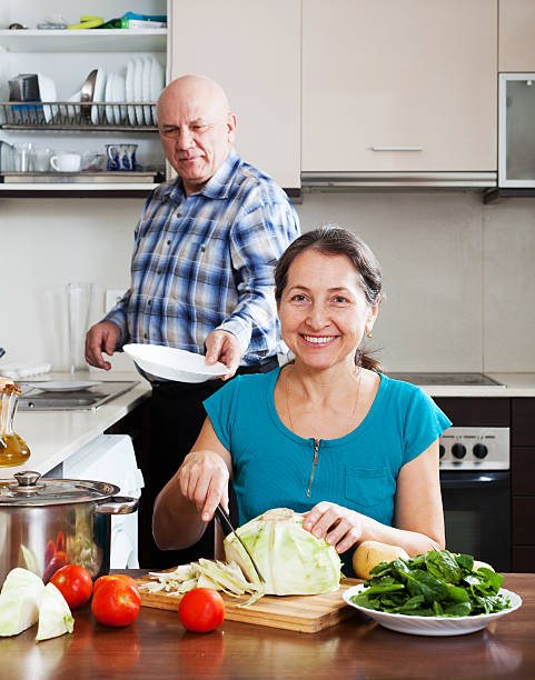 istock man and mature woman  doing housework together 501618579