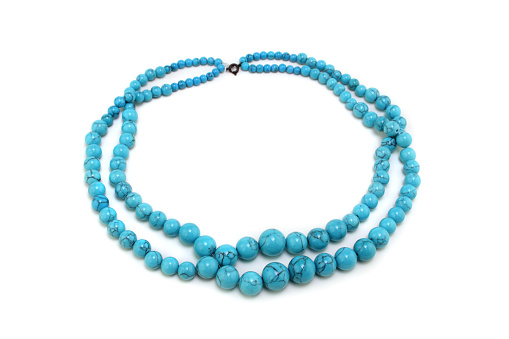 Turquoise necklace on pure white background, with soft shadows.