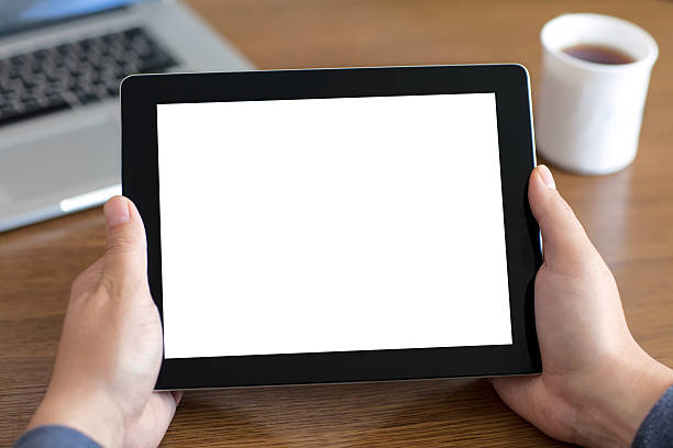 istock male hands holding tablet with isolated screen of the table 501619249