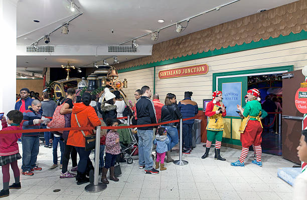 People on line to visit Santa inside Macy's in NYC stock photo