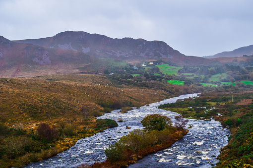 A river splits as it runs through the majestic Irish countryside
