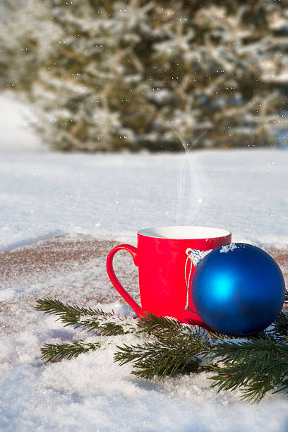 istock red mug with Christmas balls in the winter forest 501629318