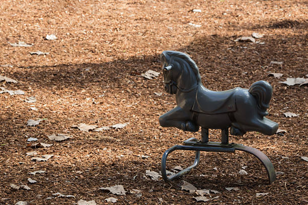 A gray horse toy at the playground