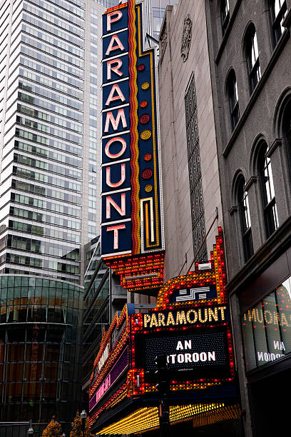 Old Paramount Theater Neon Sign Boston, MA, USA -- December 13, 2015: Old Paramount Theater sign remaining on building which is now owned by a local college . This building is now used to conduct performing arts. paramount studios stock pictures, royalty-free photos & images