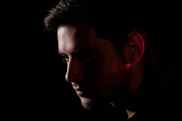 istock portrait of a young man on a black background 501631366
