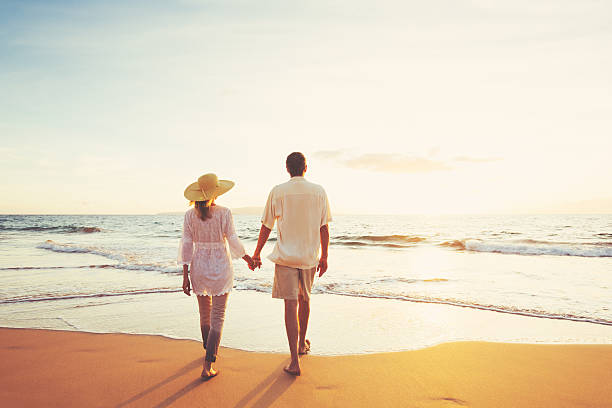istock Mature Couple Walking on the Beach at Sunset 501631872