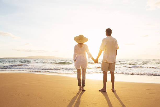 istock Mature Couple Walking on the Beach at Sunset 501631934