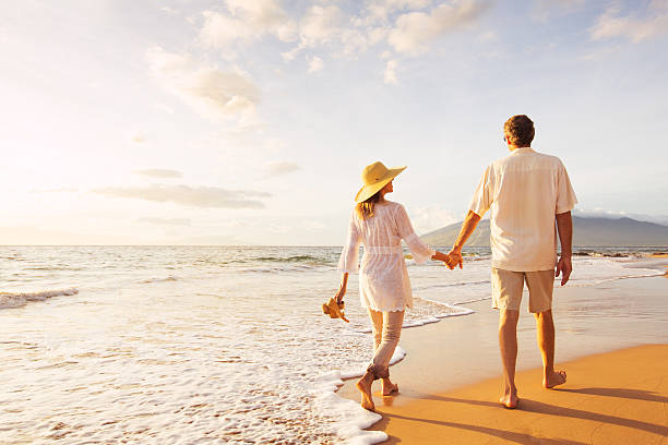 istock Mature Couple Walking on the Beach at Sunset 501632120