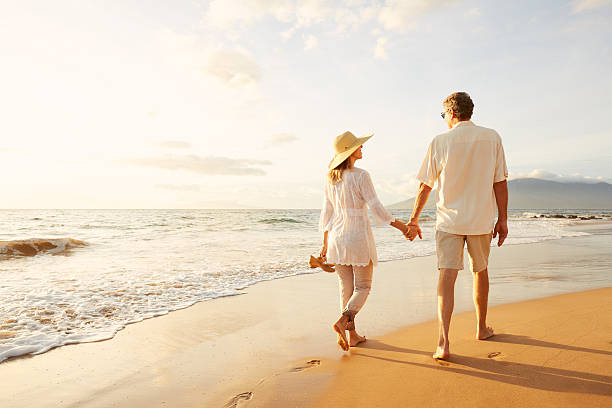 istock Mature Couple Walking on the Beach at Sunset 501632206