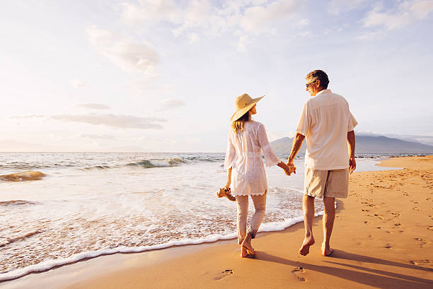 istock Mature Couple Walking on the Beach at Sunset 501632292