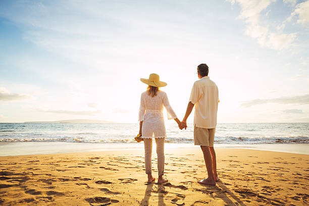 istock Mature Couple Walking on the Beach at Sunset 501640484